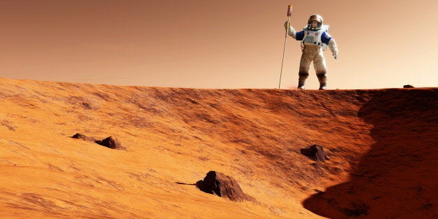 Astronaut on Mars. Artwork of an astronaut holding experimental equipment standing on the edge of a Martian crater. The Martian atmosphere is mostly carbon dioxide and surface temperatures are well below freezing. Martian astronauts will have to breathe their own air supply and wear heated spacesuits on the surface of Mars. Mars is a rocky desert world and has no surface water. The gravity is about one third of that on Earth.