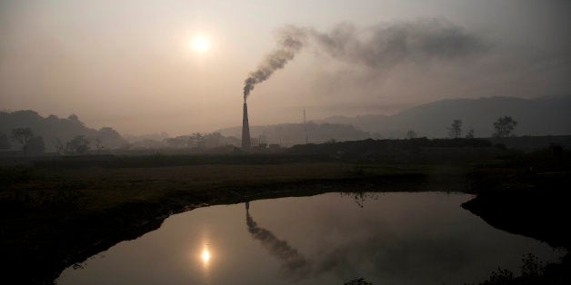 Smoke rises from a brick kiln on the outskirts of Gauhati, India, Monday, Jan. 26, 2015. The White House is hoping that the s