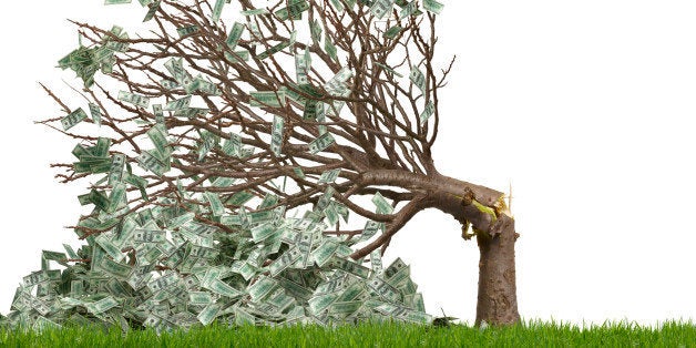 Money tree snapped over with money falling to the ground, US currency