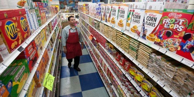 In this photo taken Thursday, Nov. 1, 2012, Grocery market owner Ray Martinez poses for a photo at La Playa Market in Inglewood, Calif. Martinez opposes the passing of California Proposition 37, Mandatory Labeling of Genetically Engineered Food. For every unmarked item at his Inglewood store, Martinez would need to get a sworn statement from suppliers or get independent certification confirming products are GMO-free. (AP Photo/Damian Dovarganes)