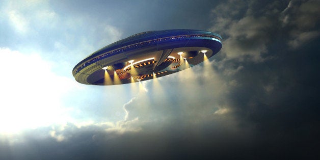 Alien UFO saucer flying on a clouds background above Earth