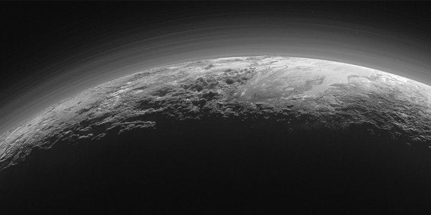 This July 14, 2015 photo released by NASA on Thursday, Sept. 17, 2015 shows the atmosphere and surface features of Pluto, lit from behind by the sun. It was made 15 minutes after the New Horizons' spacecraft's closest approach. (NASA/JHUAPL/SwRI via AP)