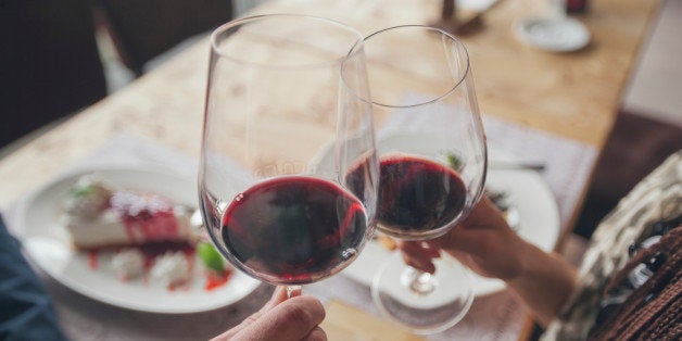 Couple toasting with wine in cafe