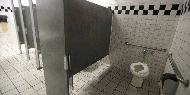 A disabled toilet stall is shown in the boys bathroom where police were investigating reports of a brutal assault of a transg