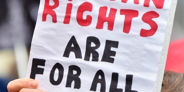 A woman holds a placard reading 'Human rights are for all' as she takes part in a rally of Ukrainian activists and representatives of lesbian, gay, bisexual, and transgender (LGBT) community, in front of the parliament in Kiev during a hearing on November 10, 2015. Ukrainian lawmakers debates prior their voting a bill banning discrimination against gays at work -- a precondition for visa-free travel to most EU nations. AFP PHOTO/ SERGEI SUPINSKY (Photo credit should read SERGEI SUPINSKY/AFP/Getty Images)