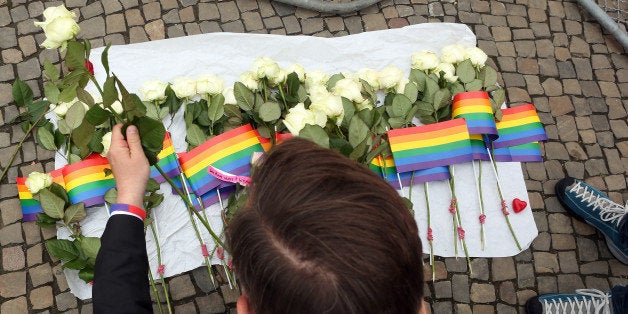 BERLIN, GERMANY - JUNE 13: A visitor places flowers at a makeshift memorial during a vigil for victims of a shooting at a ga