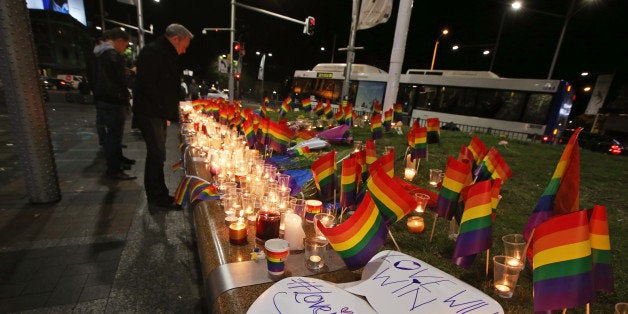 An impromptu memorial is set up in Sydney, Monday, June 13, 2016, following the Florida mass shooting at the Pulse Orlando nightclub where police say a gunman wielding an assault-type rifle opened fire, killing at least 50 people and wounding dozens. Australian Prime Minister Malcolm Turnbull said that the Orlando mass shooting was "an attack on all of us â on all our freedoms, the freedom to gather together, to celebrate, to share time with friends." (AP Photo/Rick Rycroft)