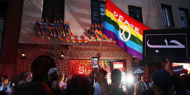 NEW YORK, NY - JUNE 12: Mourners gather outside of the iconic New York City gay and lesbian bar the Stonewall Inn to light candles,lay flowers and grieve for those killed in Orlando last evening on June 12, 2016 in New York City. An American-born man who'd recently pledged allegiance to ISIS killed 50 people early Sunday at a gay nightclub in Orlando, Florida. The massacre was the deadliest mass shooting in the United States. (Photo by Spencer Platt/Getty Images)