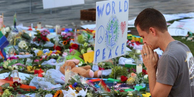 Matt Mitchell, 42, who was born and raised in Orlando, takes a moment Tuesday, June 14, 2016 to pray at a growing memorial a