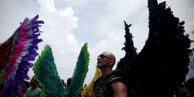 Revellers take part in a LGBT Pride Parade in Copacabana beach in Rio de Janeiro, Brazil, November 15, 2015. REUTERS/Pilar Olivares