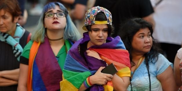 Mourners observe a minute of silence outside Barcelona's city hall during a vigil at Sant Jaume Square in Barcelona on June 1