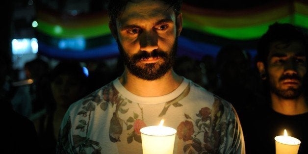 TOKYO, JAPAN - JUNE 14 : People pay tribute to victims of shooting at Pulse Nightclub in Orlando by holding banners and lighting candles, on June 14, 2016 at Shinjuku Ni-chome neighborhood of Tokyo, Japan. Omar Mateen opened fire at the Pulse nightclub early Sunday, killing 49 people and wounding 53 others before dying in a shootout with police. (Photo by DAVID MAREUIL/Anadolu Agency/Getty Images)