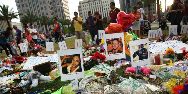 ORLANDO, FL - JUNE 16: People visit a memorial for those killed at the Pulse nightclub last Saturday night on June 16, 2016 in Orlando, Florida. Omar Mir Seddique Mateen shot the victims in what appears to be an ISIS inspired attack in which 49 people were killed early Sunday and 53 people were wounded. (Photo by Spencer Platt/Getty Images)