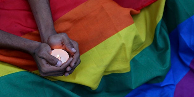 A participant holds a candle as activists of Indiaâs LGBT (Lesbians Gays Bisexuals Transgenders) community and their supporters hold a candle light vigil condemning the mass shooting at the Pulse nightclub in Orlando, Florida as they gather in Bangalore, India, Tuesday, June 14, 2016. (AP Photo/Aijaz Rahi)