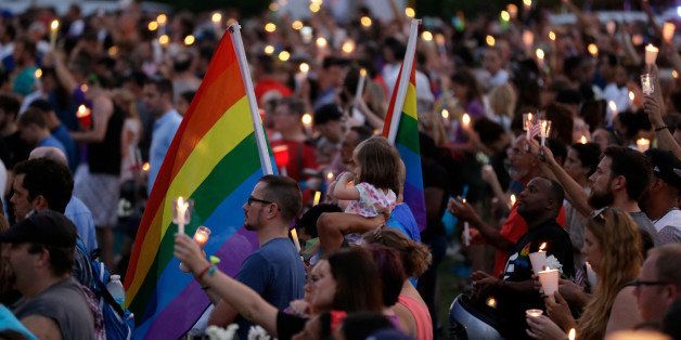 Supporters of the victims of the recent mass shooting at the Pulse nightclub attend a vigil at Lake Eola Park, Sunday, June 19, 2016, Orlando, Fla. Tens of thousands of people attended the vigil. (AP Photo/John Raoux)