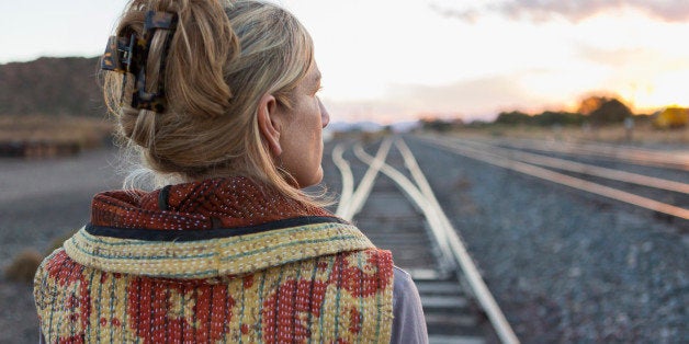 Caucasian woman standing on train tracks