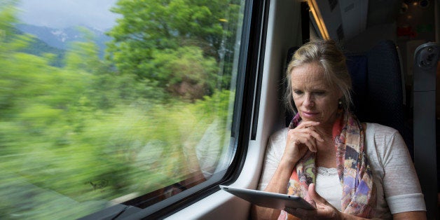 Woman uses digital tablet on board speeding train