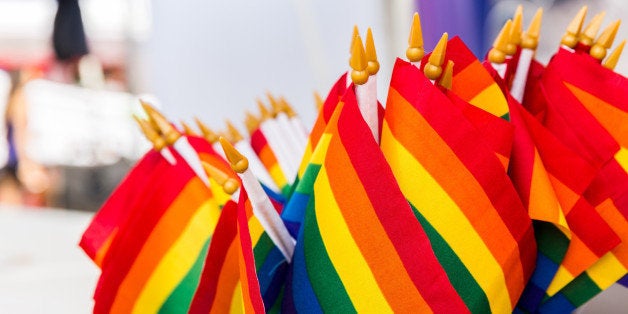 Small gay pride flags are awaiting sale.