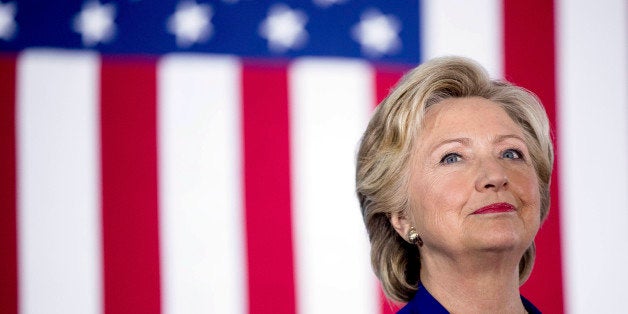 Democratic presidential candidate Hillary Clinton smiles on stage at a rally at the Plumbers and Pipe fitters Local 525 Union