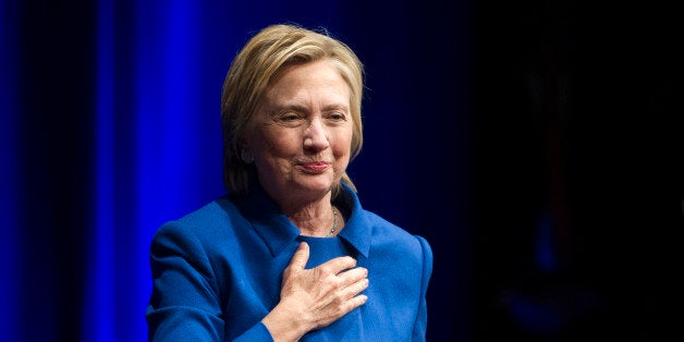 Hillary Clinton places her hand over her hand as she walks to the podium to address the Children's Defense Fund's Beat the Odds celebration at the Newseum in Washington, Wednesday, Nov. 16, 2016. (AP Photo/Cliff Owen)