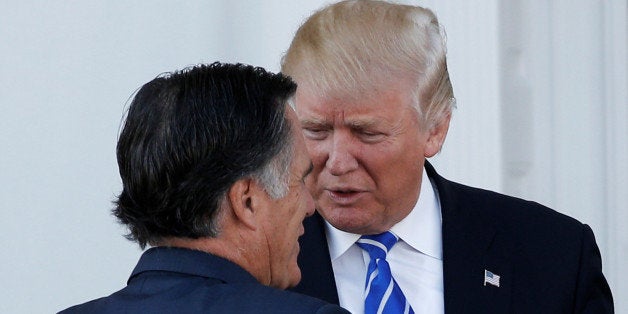 U.S. President-elect Donald Trump greets former Massachusetts Governor Mitt Romney (L) as he arrives for their meeting at the