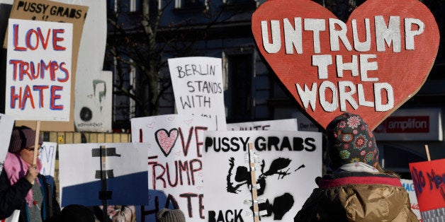 Demonstrators protesting against US president-elect Donald Trump display placards during a so called 'Pussy Grabs Back' demonstration in Berlin on November 12, 2016. / AFP / John MACDOUGALL (Photo credit should read JOHN MACDOUGALL/AFP/Getty Images)