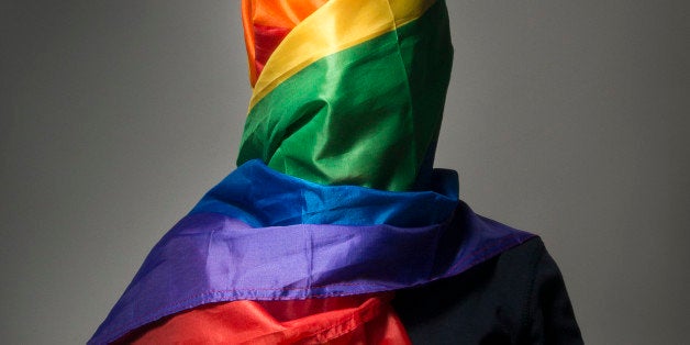 The human body wrapped in a gay flag which symbolises a muslim gay person.