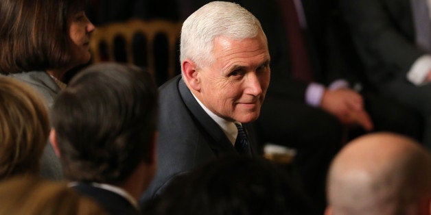 U.S. Vice President Mike Pence and his wife Karen (L) sit in the front row waiting for U.S. President Donald Trump to announc