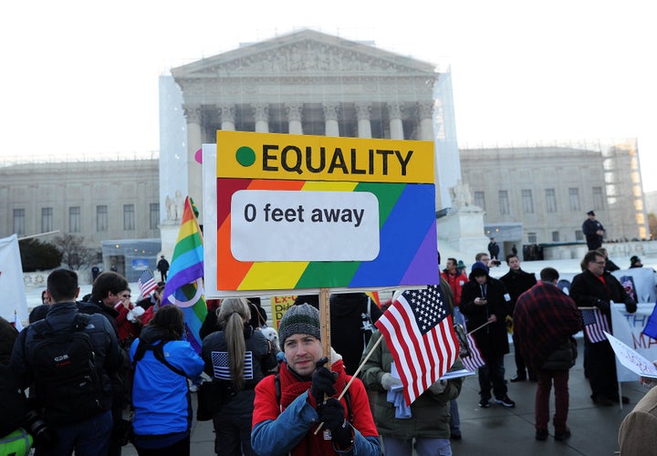 Supporters of same-sex marriage gather in front of the US Supreme Court on March 26, 2013 in Washington, DC. Same-sex marriage takes center stage at the US Supreme Court on Tuesday as the justices begin hearing oral arguments on the emotionally-charged issue that has split the nation. AFP PHOTO/Jewel Samad (Photo credit should read JEWEL SAMAD/AFP/Getty Images)