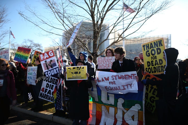 WASHINGTON, DC - MARCH 26: Protesters for and against gay marriage rally in front of the U.S. Supreme Court, on March 26, 2013 in Washington, DC. Today the high court is scheduled to hear arguments in California's Proposition 8, the controversial ballot initiative that defines marriage as between a man and a woman. (Photo by Mark Wilson/Getty Images)