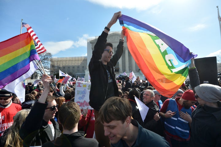 Same-sex marriage supporters demonstrate in front of the Supreme Court on March 27, 2013 in Washington, DC. The rights of married same-sex couples will come under scrutiny at the US Supreme Court on Wednesday in the second of two landmark cases being considered by the top judicial panel. After the nine justices mulled arguments on a California law that outlawed gay marriage on Tuesday, they will take up a challenge to the legality of the Defense of Marriage Act (DOMA). The 1996 law prevents couples who have tied the knot in nine states -- where same-sex marriage is legal -- from enjoying the same federal rights as heterosexual couples. AFP PHOTO/Jewel Samad (Photo credit should read JEWEL SAMAD/AFP/Getty Images)