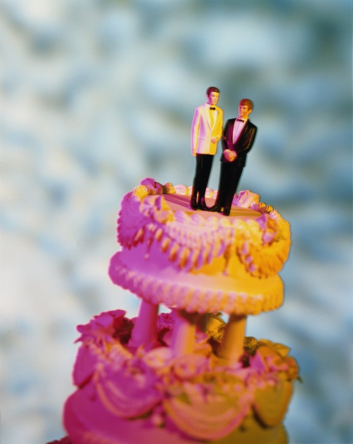 Wedding cake with two male figures on top