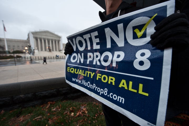 A man holds a sign against California's Proposition 8 which bans same-sex marriage in front of the US Supreme Court in Washin