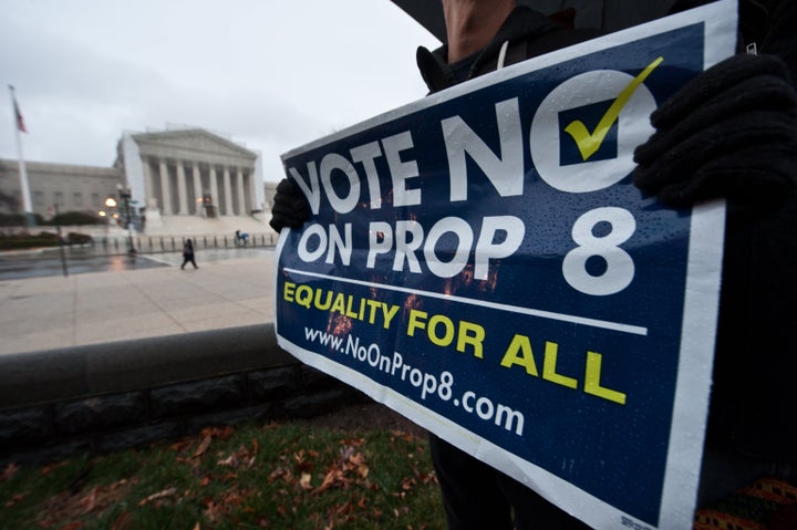 A man holds a sign against California's Proposition 8 which bans same-sex marriage in front of the US Supreme Court in Washington on March 25, 2013. The justices will hear arguments on March 26 on California's Proposition 8 ban on same-sex marriage and on March 27 on the federal Defense of Marriage Act, which defines marriage as between one man and one woman. AFP PHOTO/Nicholas KAMM (Photo credit should read NICHOLAS KAMM/AFP/Getty Images)