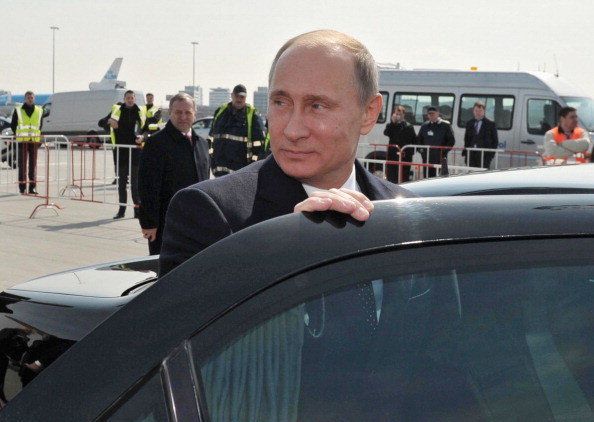 Russia's President Vladimir Putin takes a seat in a limo after his arrival at Schiphol airport near Amsterdam, on April 8, 2013. Putin's visit is part of the opening of the year of celebration in Dutch-Russian relations. AFP PHOTO/ RIA-NOVOSTI POOL / ALEXEY DRUZHININ (Photo credit should read ALEXEY DRUZHININ/AFP/Getty Images)