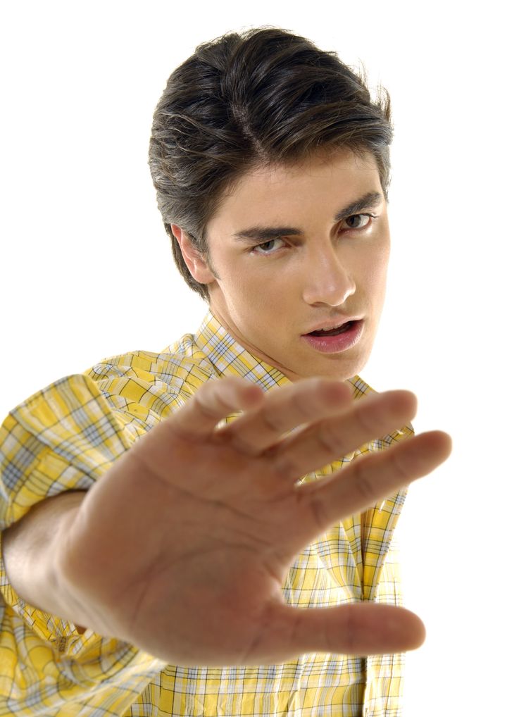 Portrait of a young man making a stop gesture