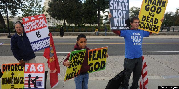 WASHINGTON, DC - OCTOBER 6: Demonstrators from the Westboro Baptist Church (L-R) Betty Phelps, Daniel Phelps, 9, and Jacob Phelps, 27, of Topeka, Kansas, gather outside the U.S. Supreme Court as the court hears the case of Snyder v. Phelps in Washington, D.C., on Wednesday, October 6, 2010. (Photo by Nikki Kahn/The Washington Post via Getty Images)