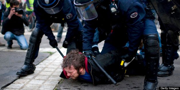 A pro gay marriage militant is arrested by anti-riot police officers during a demonstration by supporters of the anti-gay marriage movement 'La Manif Pour Tous' (Demonstration for all!) on April 18, 2013 in Nantes, western France. The final vote on France's landmark bill allowing gay marriage has been fast-tracked to next week. The bill has proved hugely controversial in a country that is officially secular but predominantly Catholic, mobilising hundreds of thousands of people for months in pro-and anti same-sex marriage protests nationwide, some violent. AFP PHOTO / JEAN-SEBASTIEN EVRARD (Photo credit should read JEAN-SEBASTIEN EVRARD/AFP/Getty Images)