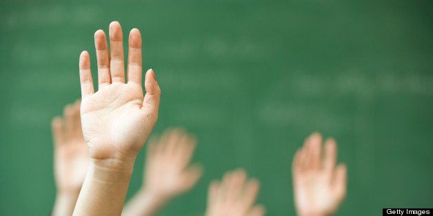 Hands raised in classroom
