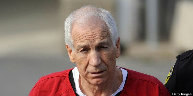 Jerry Sandusky, center, is escorted from his sentencing at the Centre County Courthouse in Bellefonte on Tuesday, October 9, 2012. Sandusky, maintaining his innocence, was sentenced Tuesday to at least 30 years in prison, effectively a life sentence, in the child sexual abuse scandal that brought shame to Penn State and led to coach Joe Paterno's downfall. (Christopher Weddle/Centre Daily Times/MCT via Getty Images)