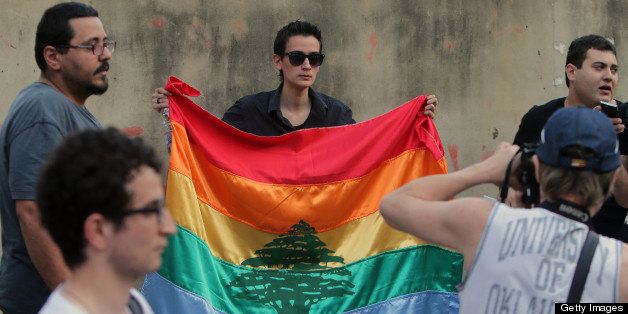 A woman holds a gay pride flag bearing a cedar tree in the center during an anti-homophobia rally in Beirut on April 30, 2013. Lebanon has a reputation as the most liberal country in the conservative Middle East, but even a night on the town for gays can end in arrest and humiliating sexuality 'tests'. The Article 534 of the Lebanese penal code punishes 'unnatural sexual intercourse' by up to one year in prison. AFP PHOTO/JOSEPH EID (Photo credit should read JOSEPH EID/AFP/Getty Images)
