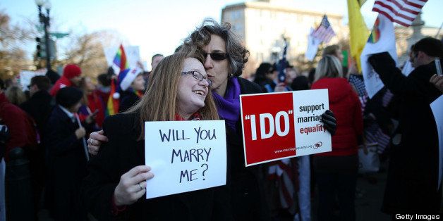 WASHINGTON, DC - MARCH 26: Andrea Grill (R) and Lee Ann Hopkins (L), from Alexandria VA. embrace after becoming engaged during a rally outside of the U.S Supreme Court, on March 26, 2013 in Washington, DC. Today the high court is scheduled to hear arguments in California's proposition 8, the controversial ballot initiative that defines marriage as between a man and a woman. (Photo by Mark Wilson/Getty Images)
