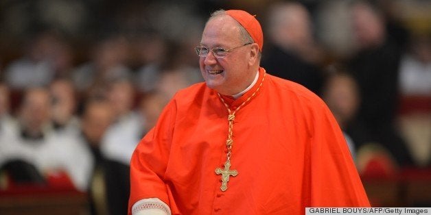 US cardinal Timothy Michael Dolan attends a mass at the St Peter's basilica before the conclave on March 12, 2013 at the Vatican. Cardinals moved into the Vatican today as the suspense mounted ahead of a secret papal election with no clear frontrunner to steer the Catholic world through troubled waters after Benedict XVI's historic resignation.The 115 cardinal electors who pick the next leader of 1.2 billion Catholics in a conclave in the Sistine Chapel will live inside the Vatican walls completely cut off from the outside world until they have made their choice. AFP PHOTO / GABRIEL BOUYS (Photo credit should read GABRIEL BOUYS,GABRIEL BOUYS/AFP/Getty Images)