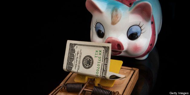 a colorful and unsuspecting porcalain piggy bank is about to get a headache from a large (rat) piggy trap that is baited with a 100 dollar bill. Lighting dark and moody
