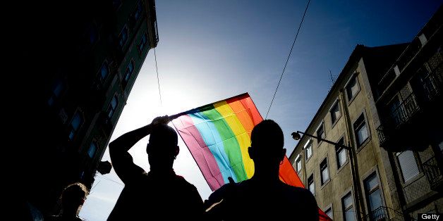 A man waves a rainbow flag as he takes part in the Gay Pride Parade in Lisbon on June 22, 2013. AFP PHOTO/ PATRICIA DE MELO MOREIRA (Photo credit should read PATRICIA DE MELO MOREIRA/AFP/Getty Images)
