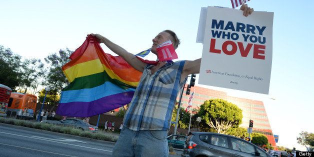 A man celebrates in West Hollywood California after the Supreme Court rulings on same-sex marriage, June 26, 2013. The US Supreme Court on Wednesday struck down the Defense of Marriage Act (DOMA), a controversial federal law that defines marriage as a union between a man and a woman and also ruled that Proposition 8, California's ban on gay marriage, could not be defended before the Supreme Court, paving the way for the resumption of gay marriages in California. AFP PHOTO / ROBYN BECK (Photo credit should read ROBYN BECK/AFP/Getty Images)