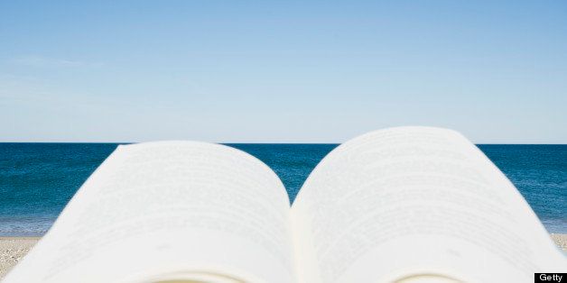 Reader's view of book and beach, Nantucket Island, Massachusetts, USA.