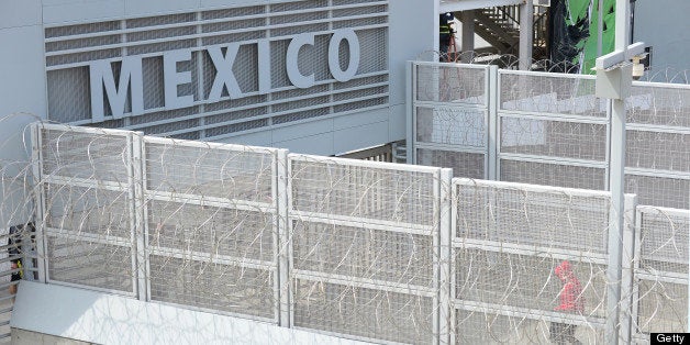 TO GO WITH AFP STORY BY LEILA MACOR 'EEUU-MIGRACIÓN-SEGURIDAD-HISPANOS' A person walks across a bridge at the US-Mexico borde