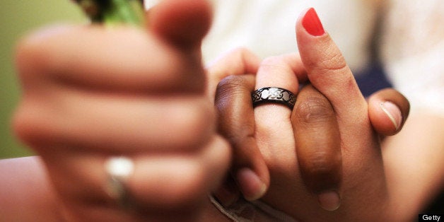 NEW YORK, NY - JUNE 27: U.S. Air Force Senior Airman Shyla Smith and Courtney Burdeshaw hold hands while waiting to get married at the Manhattan Marriage Bureau the day after the U.S. Supreme Court ruling on DOMA on June 27, 2013 in New York City. The high court struck down the Defense of Marriage Act (DOMA) and ruled that supporters of California's ban on gay marriage, Proposition 8, could not defend it before the Supreme Court. The pair said they planned to get married today before the ruling came down. (Photo by Mario Tama/Getty Images)