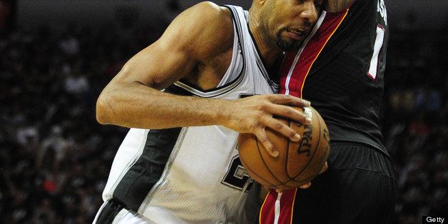Tim Duncan of the San Antonio Spurs drives to the hoop under pressure from Chris Bosh of the Miami Heat during game 5 of the NBA finals on June 16, 2013 in San Antonio, Texas. AFP PHOTO/Frederic J. BROWN (Photo credit should read FREDERIC J. BROWN/AFP/Getty Images)